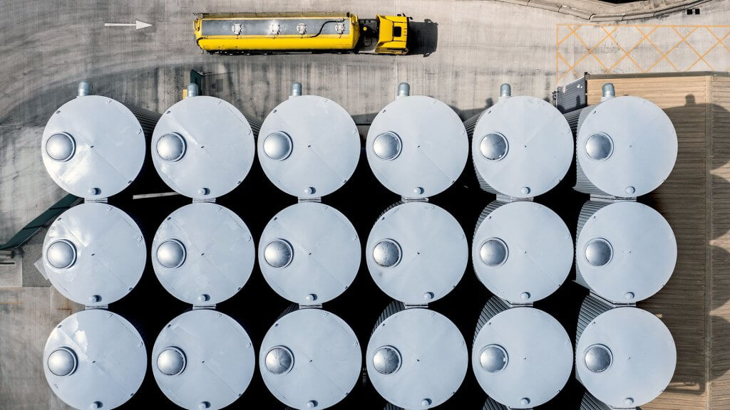 Truck parked near silos, waiting for loading