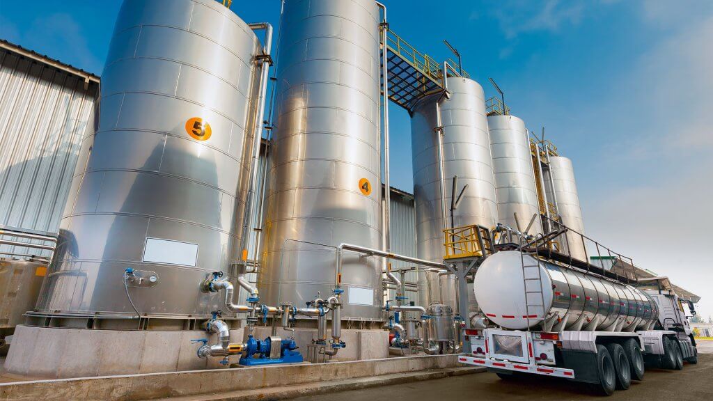 Truck in front of silos loading materials